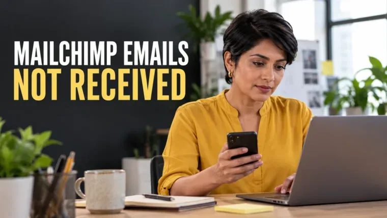 Email marketer checking a phone and laptop beside a Mailchimp emails not received headline